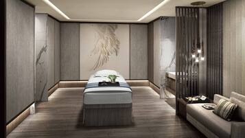 Relax in a serene space with a massage table, contemporary sofa, and abstract mural.