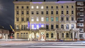 A historic building with classical architecture, featuring multiple windows and a central entrance.