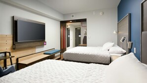 A hotel room with two beds, a TV mounted on the wall, a desk, and a bench. - Tru By Hilton Chattanooga Hamilton Place (Chattanooga)