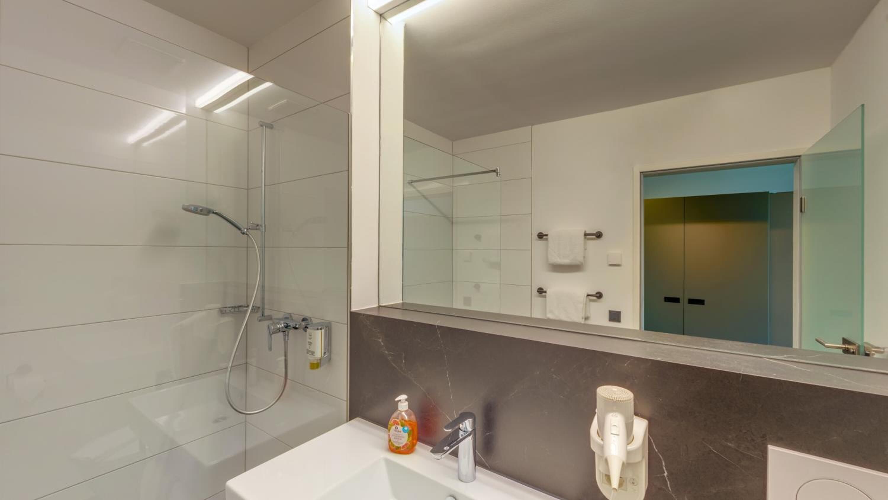 Shower, hair dryer, towels, soap