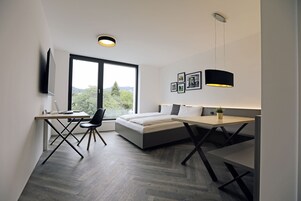 Premium bedding, desk, laptop workspace, soundproofing