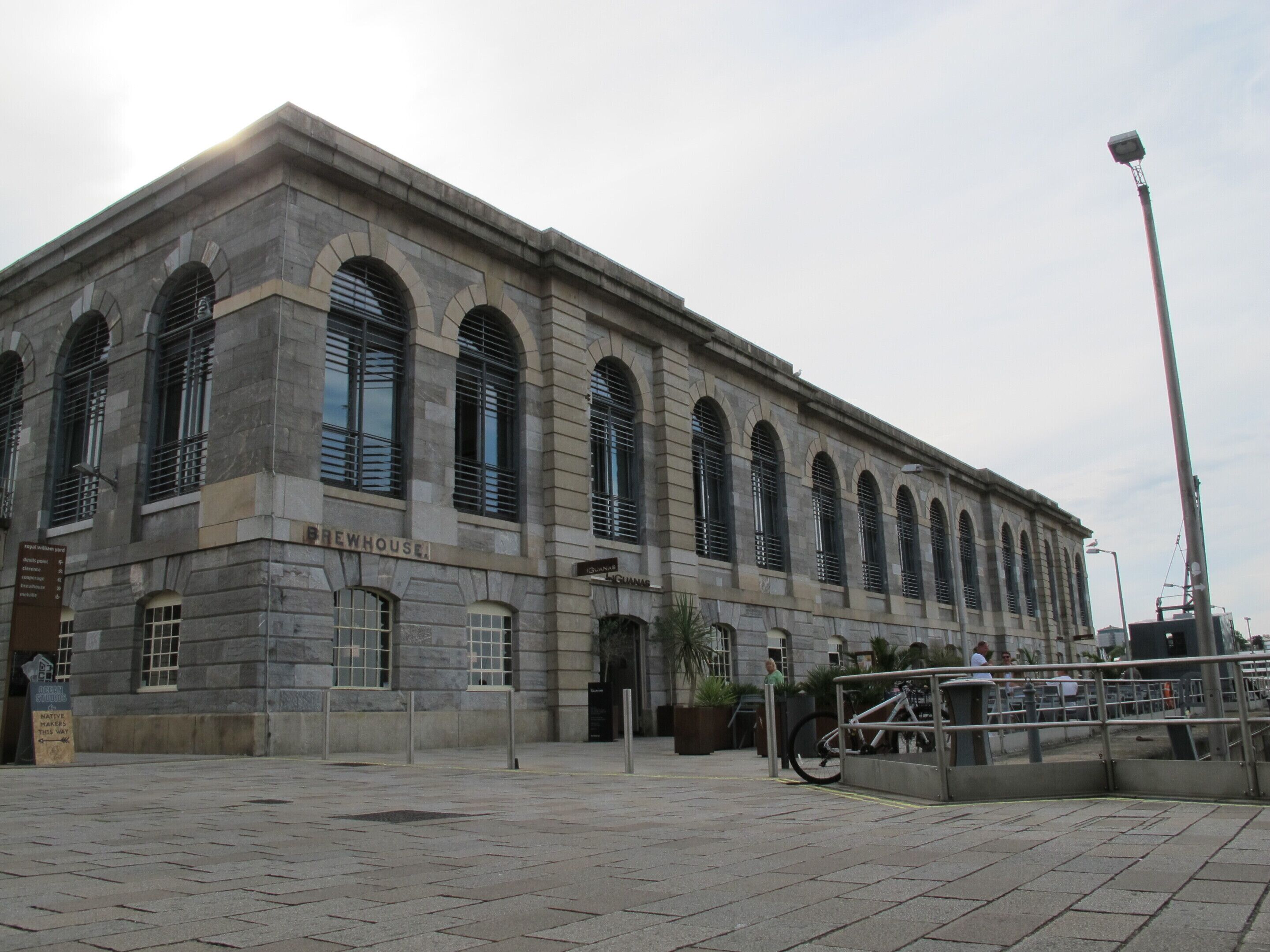 A large, historic building with arched windows and a sign reading "BREWHOUSE".
