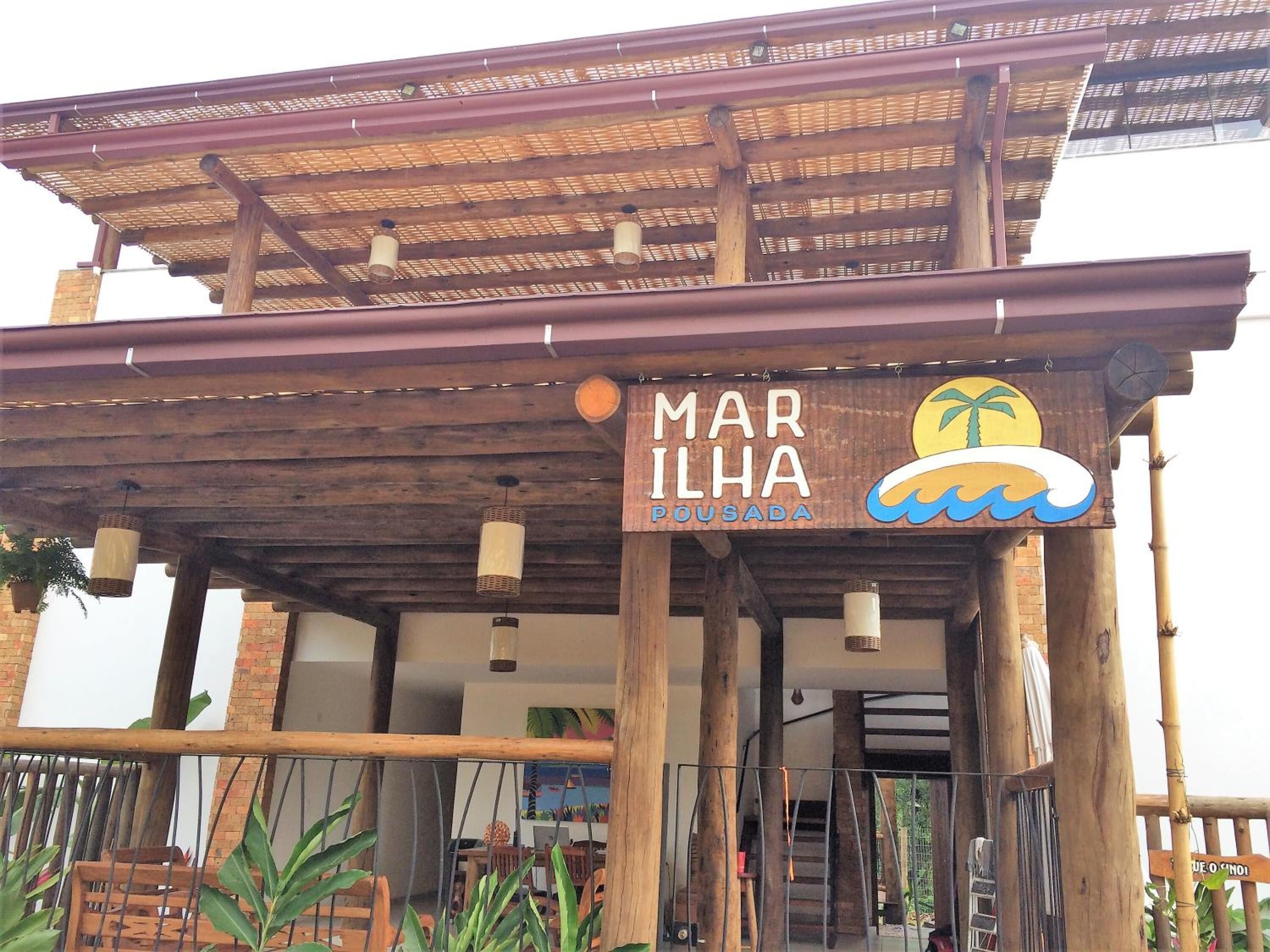 A wooden structure with a sign reading "MARILHA POUSA DA".