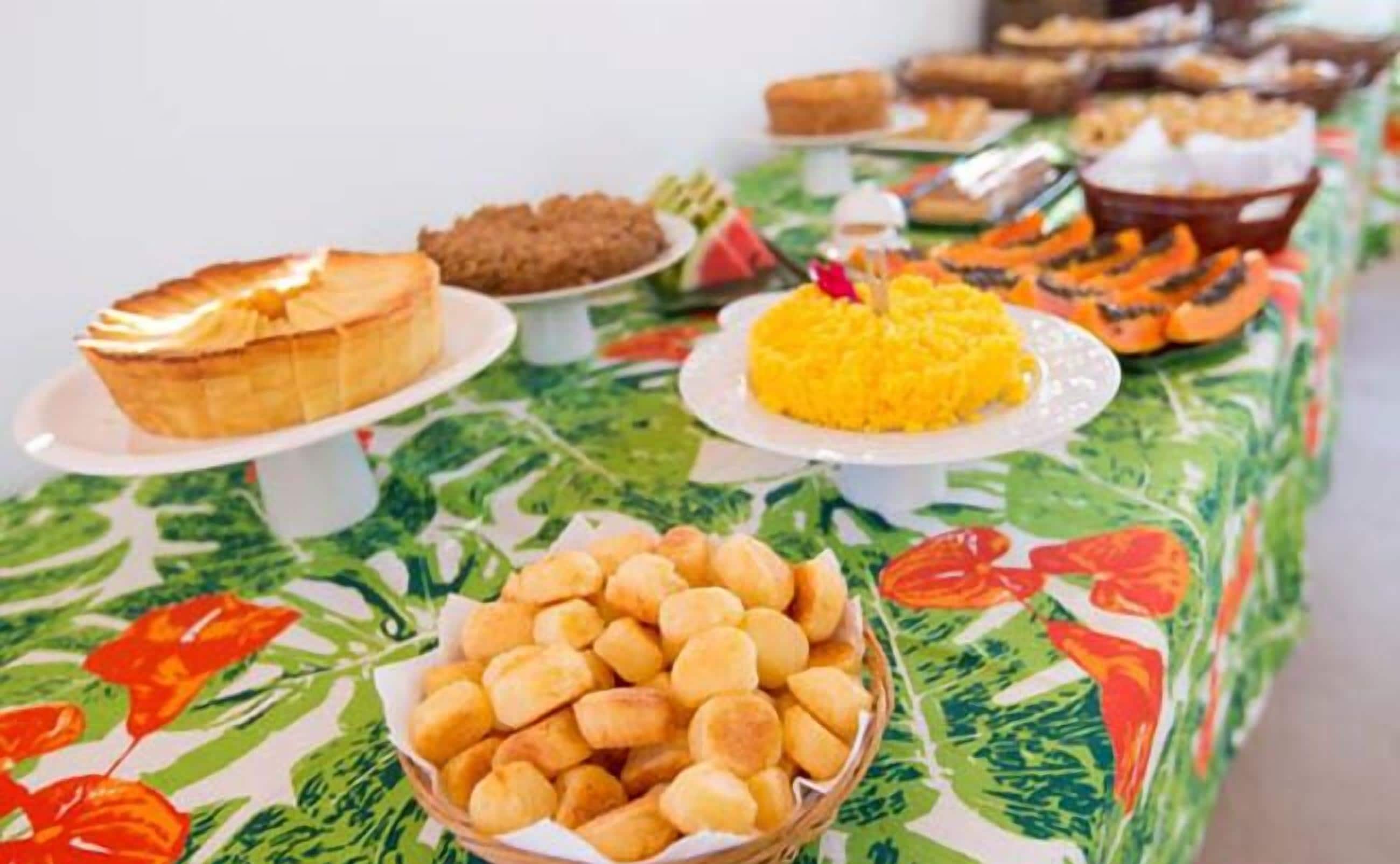 A buffet table with various dishes including bread, rice, and pastries.
