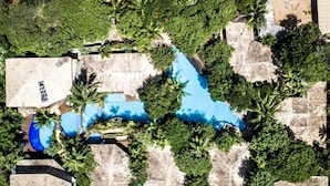 An aerial view of a resort with multiple swimming pools surrounded by lush greenery and palm trees. - Resort Sombra e Água Fresca (Tibau do Sul)