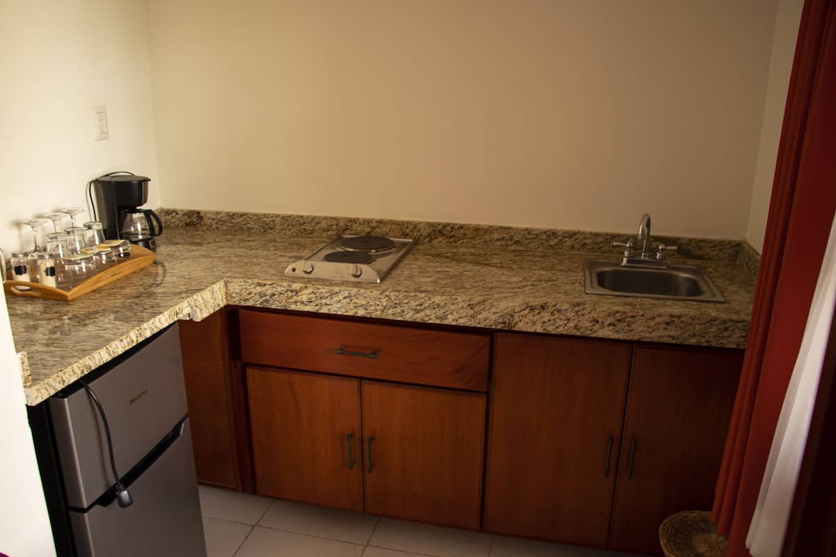 deluxe room, 1 king bed, pool view | private kitchen | coffee/tea maker