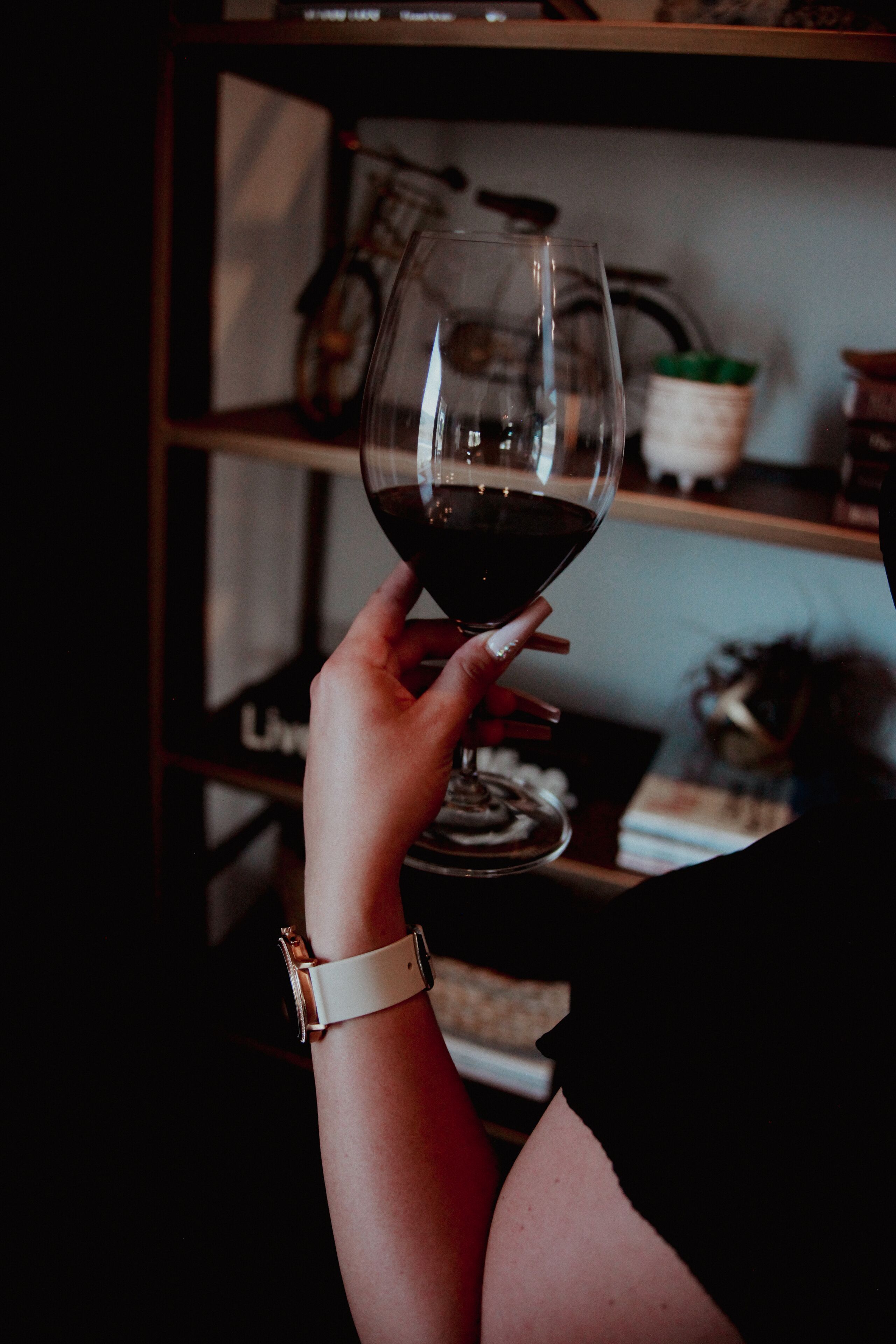 A person holding a wine glass.