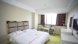 A hotel room with a large bed, a desk, a chair, and a television. - Jiaxing ShiMao Inn (Jiaxing)