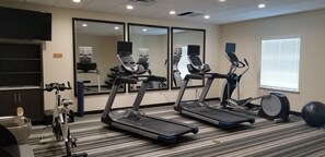 Stay active on your travels with our well-equipped fitness room featuring treadmills, a stationary bike, and dumbbells.
