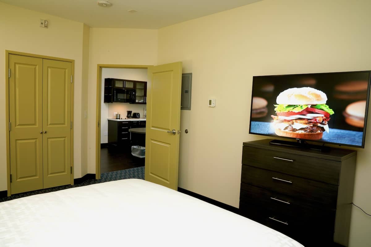 Premium bedding, desk, laptop workspace, iron/ironing board