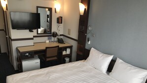 A hotel room with a bed, a desk, a chair, a television, a mirror, a telephone, and a minibar. - Toyoko Inn Ulaanbaatar (Ulaanbaatar)