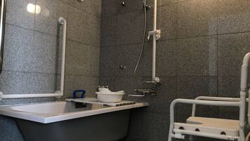 A bathroom with a bathtub, a shower, and a toilet.