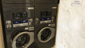 A coin laundry machine with multiple washing machines and a digital display. - Toyoko Inn Ulaanbaatar (Ulaanbaatar)