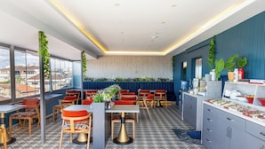 A modern restaurant with a terrace, dining area, and kitchen. - Sultanahmet Nu Hotel (Istanbul)