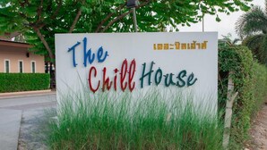 A sign for "The Chill House" with Thai text. - The Chill House (Tha Muang)