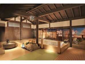 A traditional Japanese onsen with wooden beams, a stone hot spring, and a view of cherry blossoms through a window. - Oyado Tsukiyonousagi (Izumo)