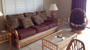 A living room with a sofa, a chair, a table, and a lamp. - Just steps to the Warm Sandy Beach of Southern Florida (Pompano Beach)