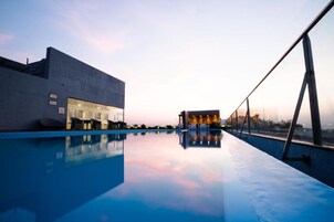 Una piscina al aire libre, una piscina en la azotea, tumbonas