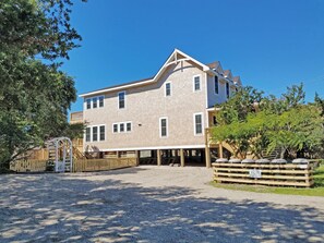 A two-story house with a sloped roof and multiple windows.