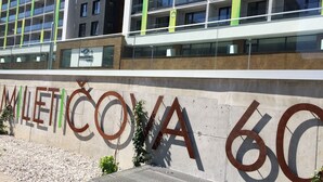 A building with a large outdoor sign reading "MILETOCOVA 60". - Quality Apartment Miletičova (Bratislava)