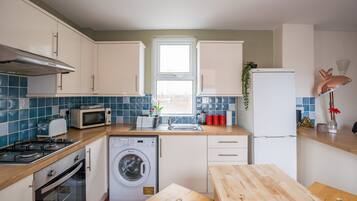 Two-Bedroom Apartment | Private kitchen | Full-size fridge, microwave, oven, stovetop