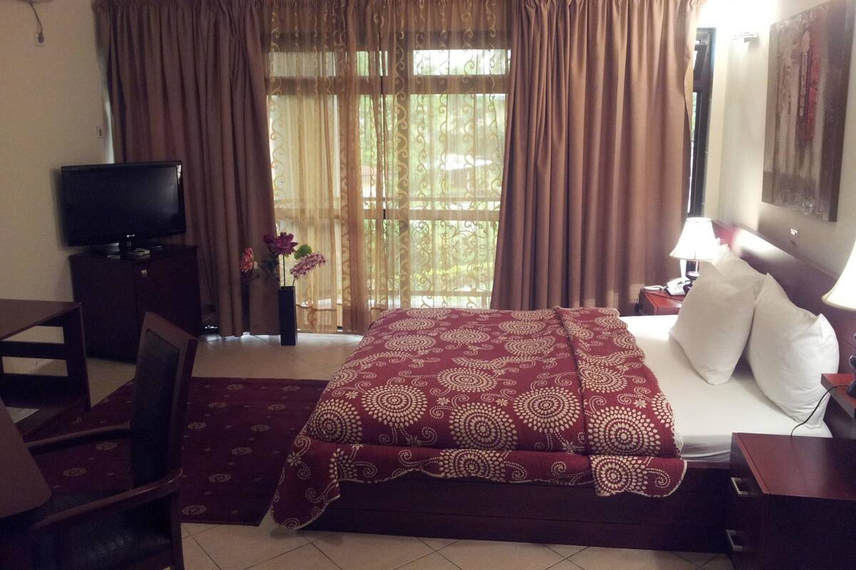 minibar, desk, blackout curtains, iron/ironing board