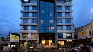 A modern hotel with a unique architectural design, featuring a curved facade and large windows. - Incredible One Hotel (Hyderabad)