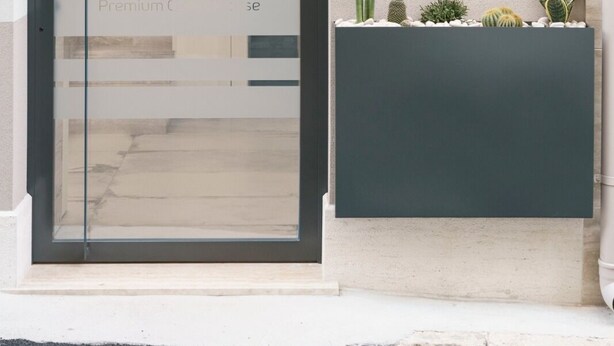 A modern building entrance with a glass door displaying the logo and name 'Aside Glo Premium Care'.
