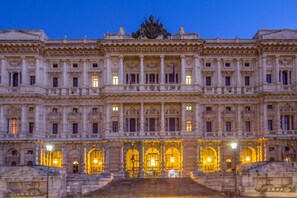 A grand historic building with classical architecture, featuring a central entrance with a staircase leading up to it. - The Shell Rome Suite (Rome)