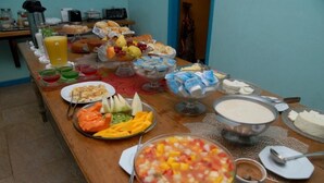 A buffet table with various food items including fruits, vegetables, and dairy products. -  Pousada Mirante do Penedo (Itatiaia)
