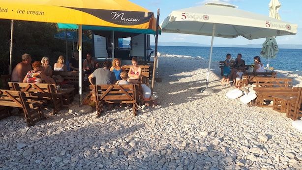 A beachside café with outdoor seating and umbrellas, overlooking the sea. - Robinson camp Val Kavran (Kavran)