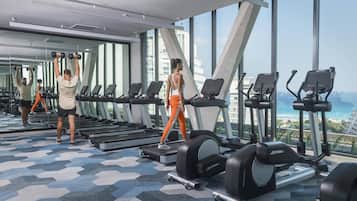 A gym with treadmills, elliptical machines, and free weights.