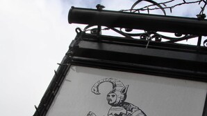 Ein Schild mit einer Ritter-Illustration und dem Text "THE CHEQUERS".