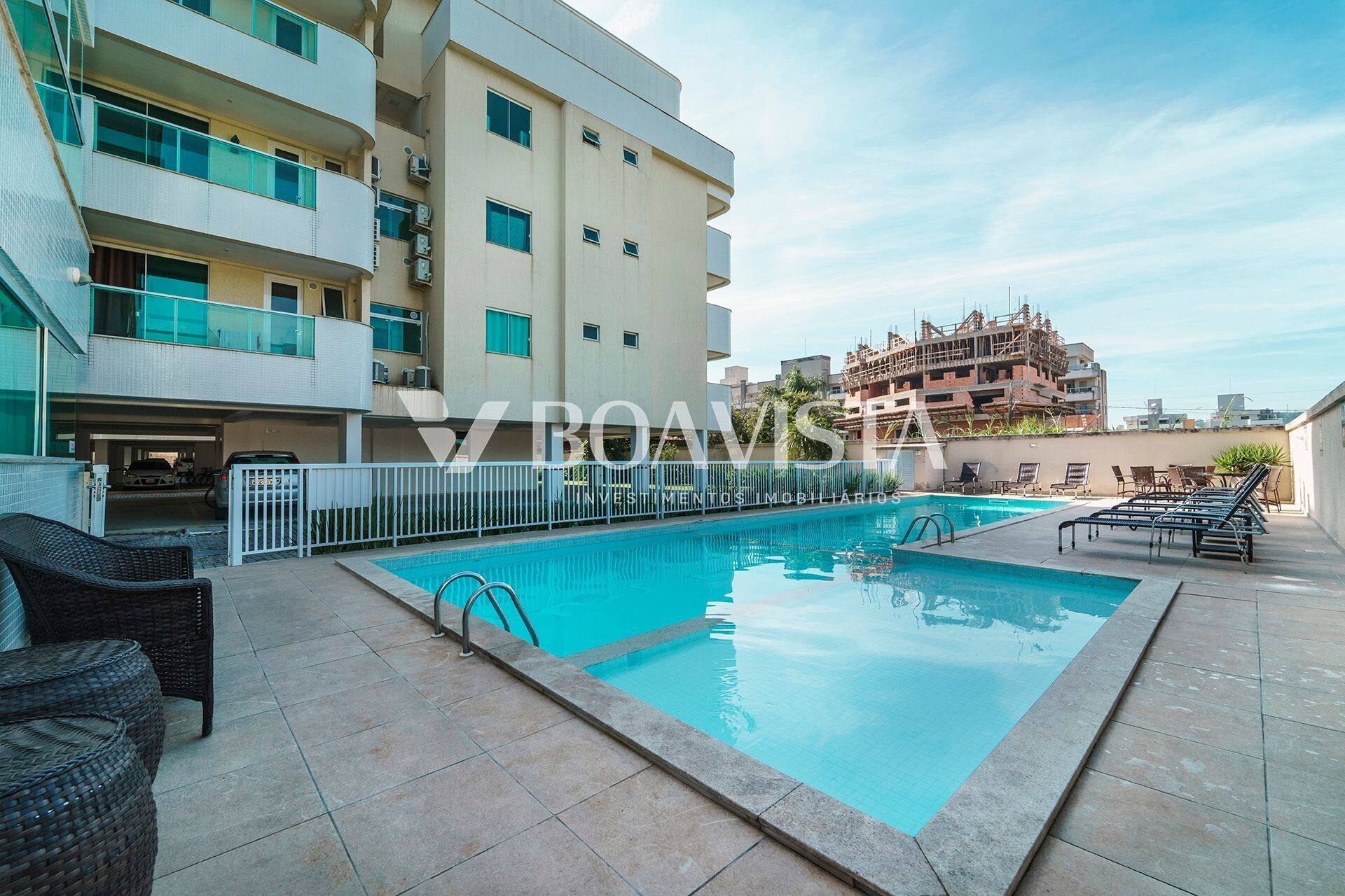 Una piscina al aire libre, sillones reclinables de piscina