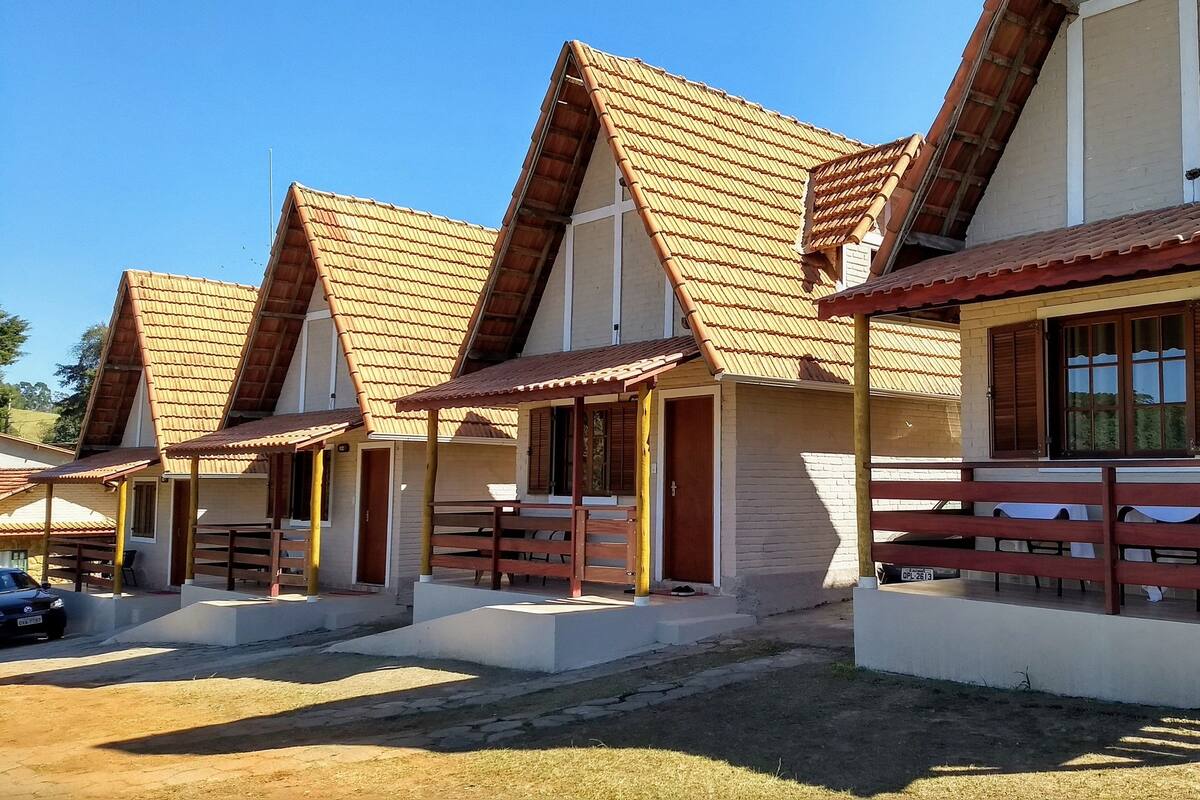 A row of traditional-style buildings with pitched roofs and wooden balconies.