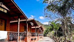 A traditional wooden building with a tiled pathway and metal railings.