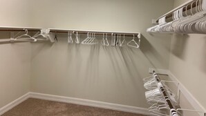 A closet with multiple white hangers and a wooden rod. - Lovely house with Sky light, Sun Room. (Mc Kinney)
