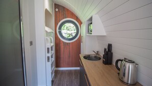 A compact kitchen with a wooden countertop, a sink, and a kettle. - Primrose Family Glamping Pod | sleeps 4 - Gold Award winning (Pickering)