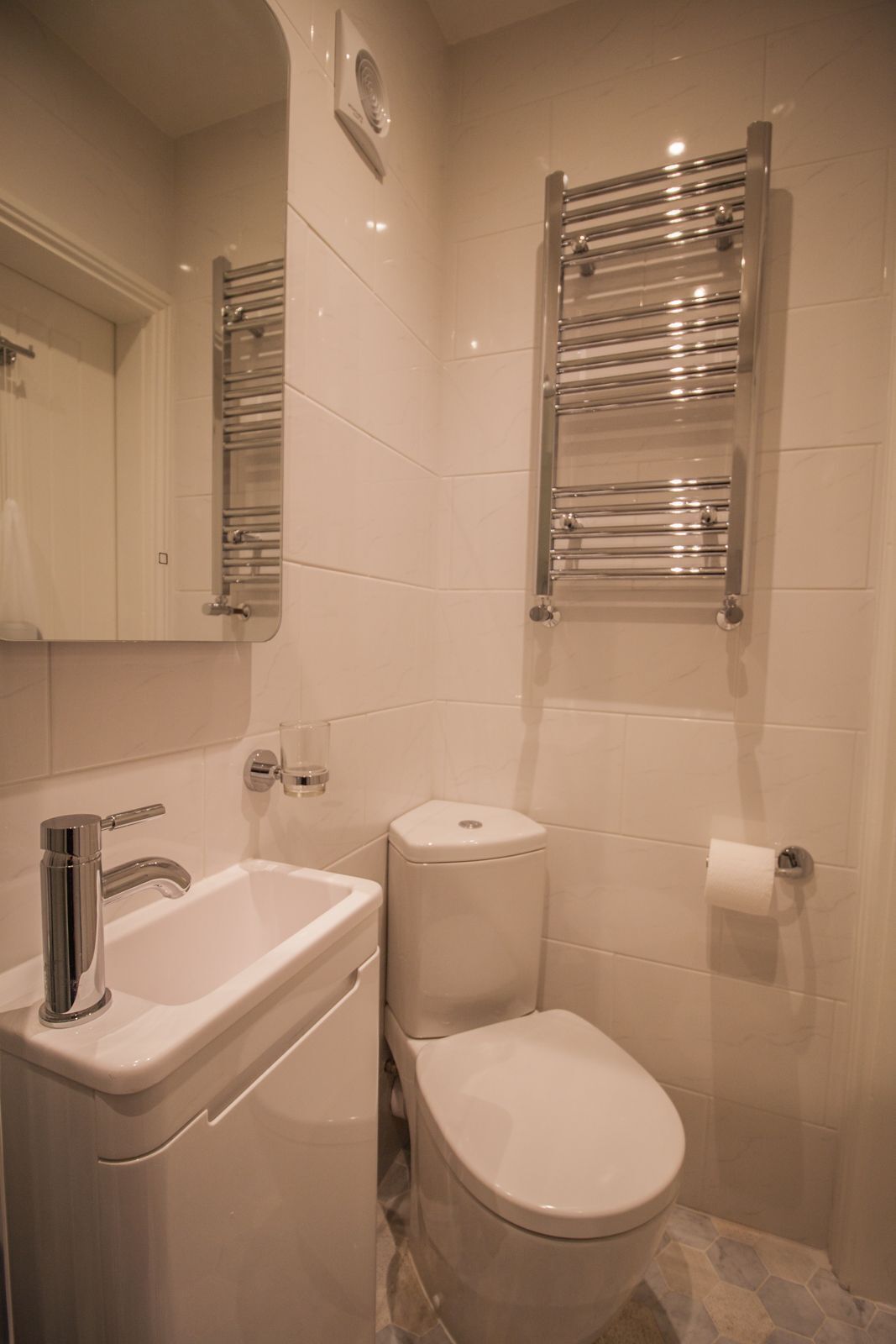 Un bagno con lavandino, WC e porta asciugamani.