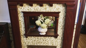A fireplace with a brick surround and a wooden mantel. - The Shepherd's Inn (Washington)