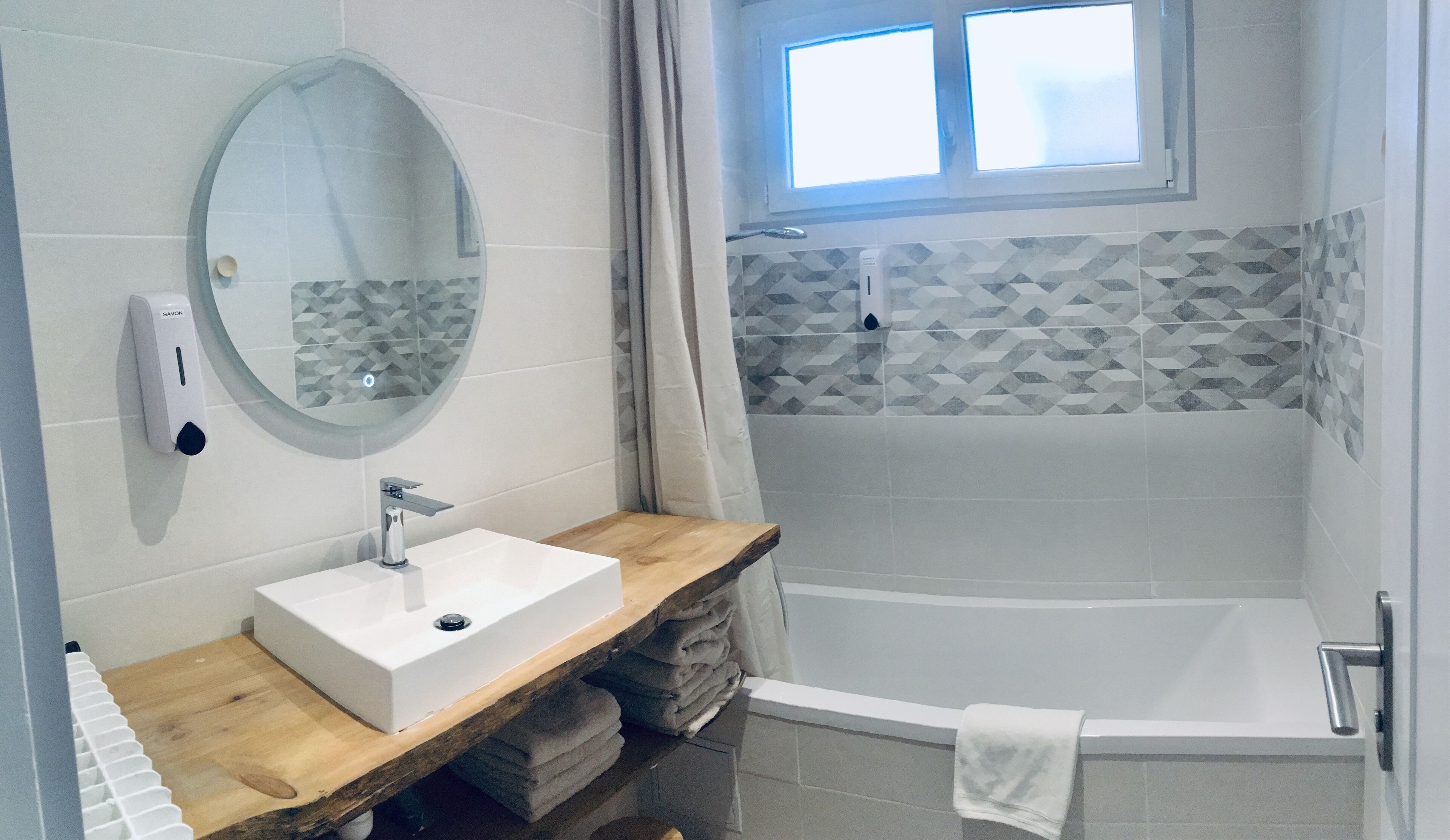 Bathtub, hair dryer, towels, soap