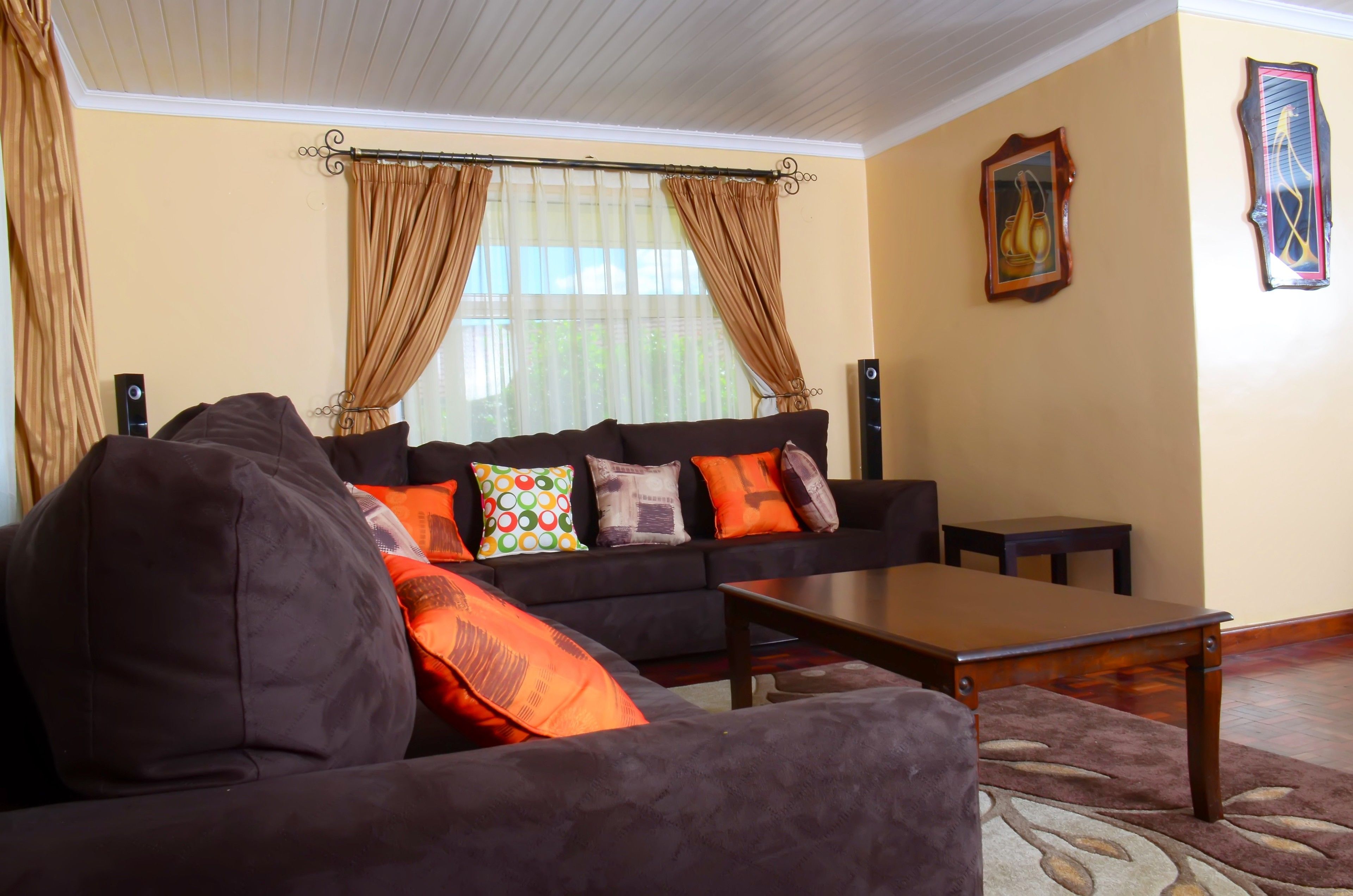 A living room with a sofa set, a coffee table, and a rug.