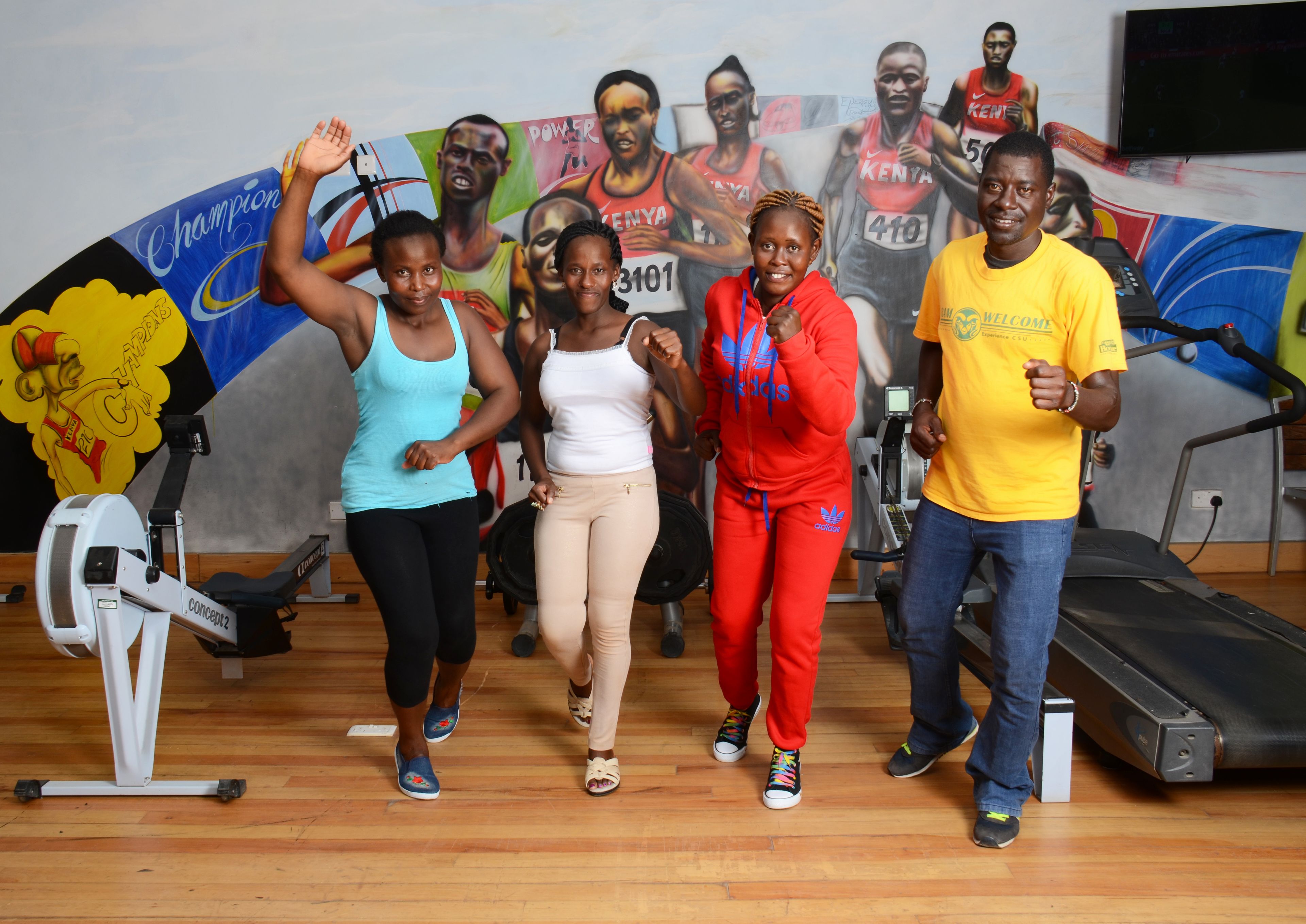 A group of people exercising in a gym with stationary bikes and treadmills.