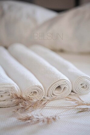 A bed with rolled white linens and dried wheat stalks. - Belsun Boutique Hotel (Kemer)