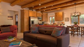 Relax in this inviting living space with a sofa, coffee table, and dining area.