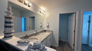 Bathtub, hair dryer, towels, toilet paper