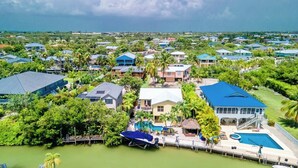 Un barrio residencial con casas, piscina y muelle.