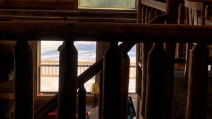 A wooden cabin with a sloped ceiling, a ceiling fan, and a window offering a mountain view. - Balsam Hollow Cabin in the Adirondacks (Bloomingdale)