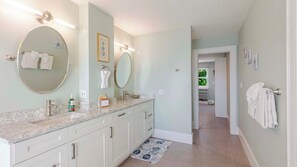 Bathtub, hair dryer, towels, toilet paper