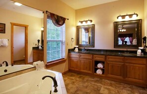 Enjoy a relaxing soak in the bathtub or freshen up at the double sink vanity.